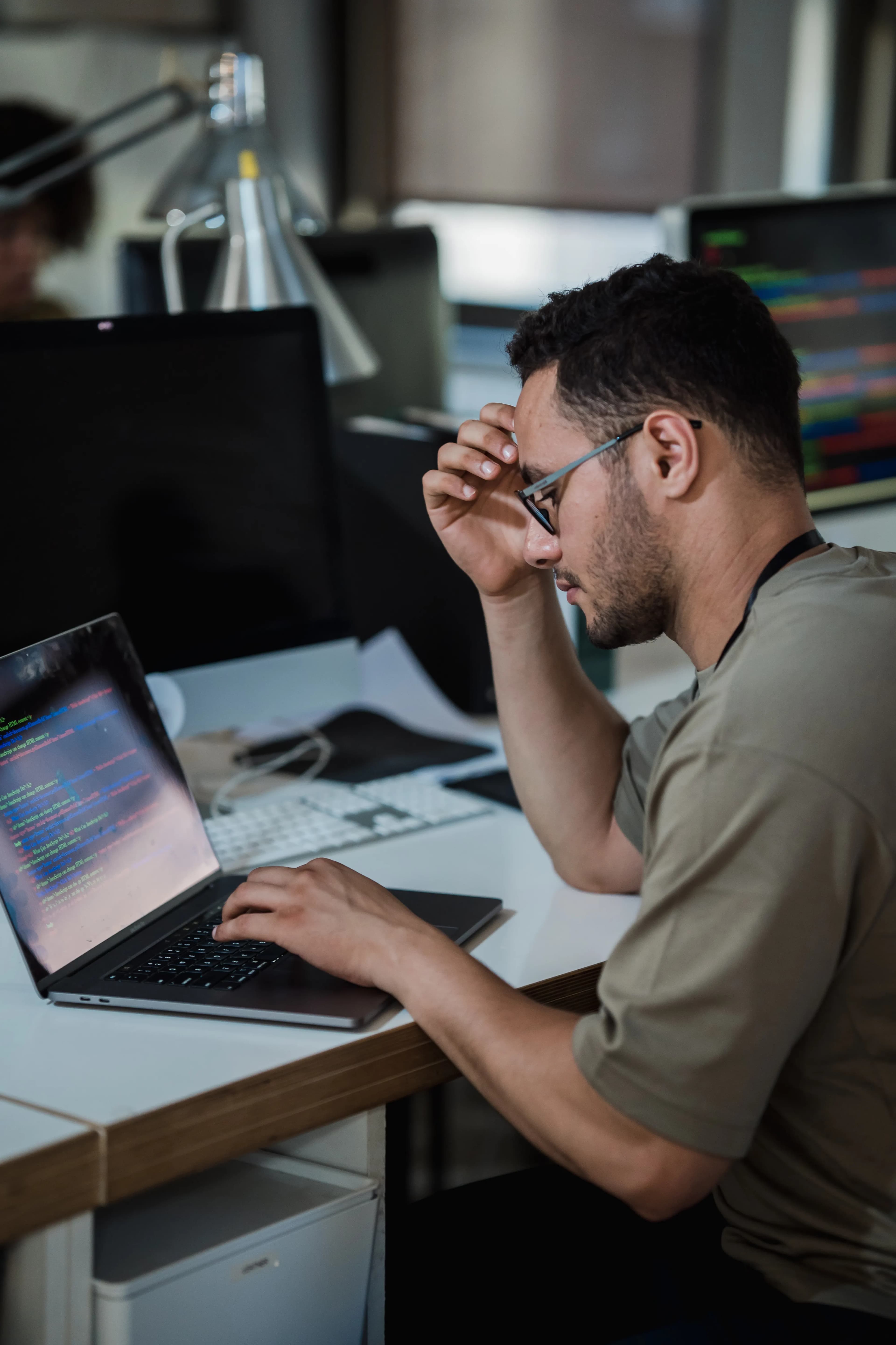 A software developer working at a laptop in an office, representing professional development services in Ontario