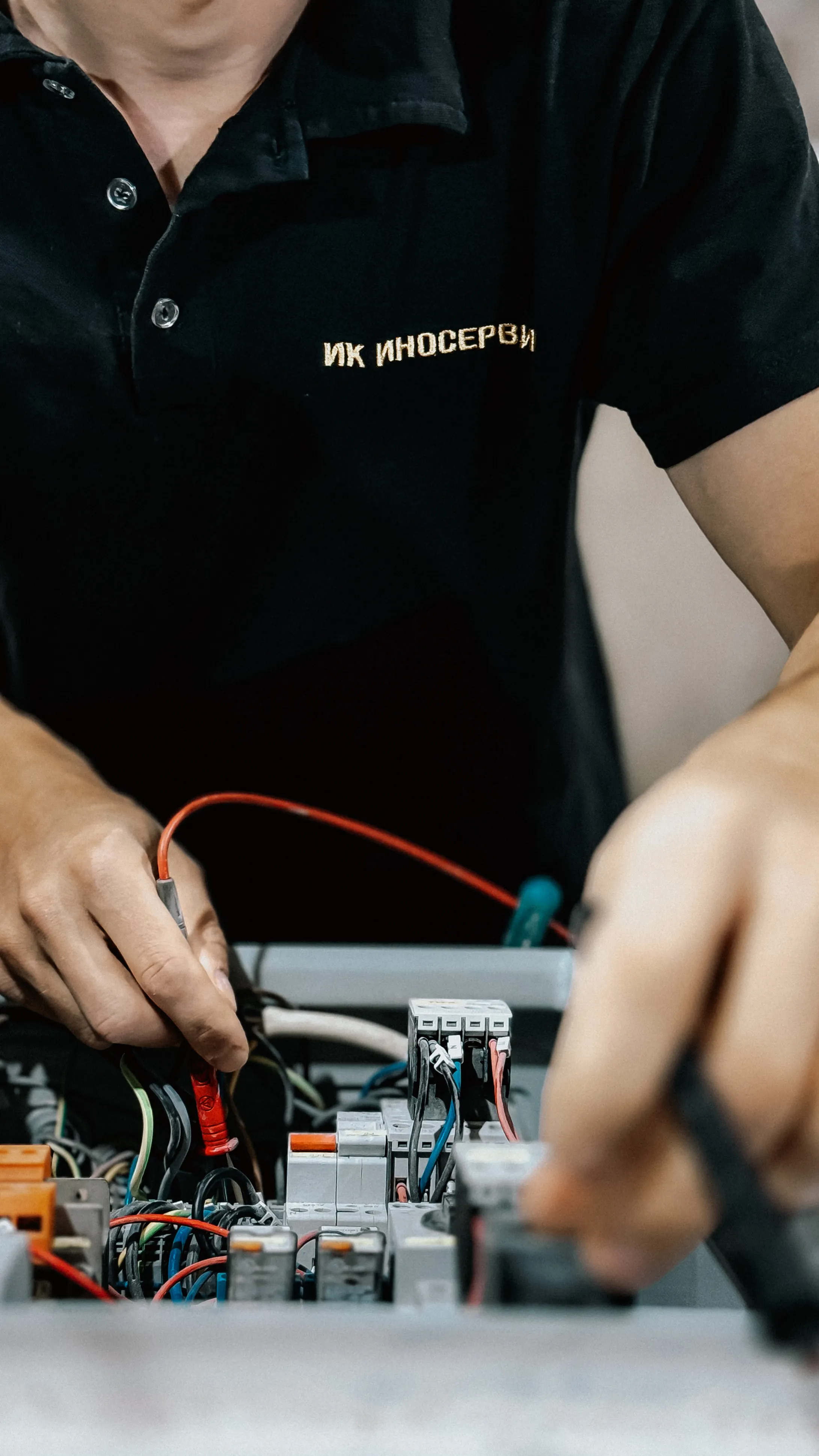 A technician repairing an electrical circuit board.