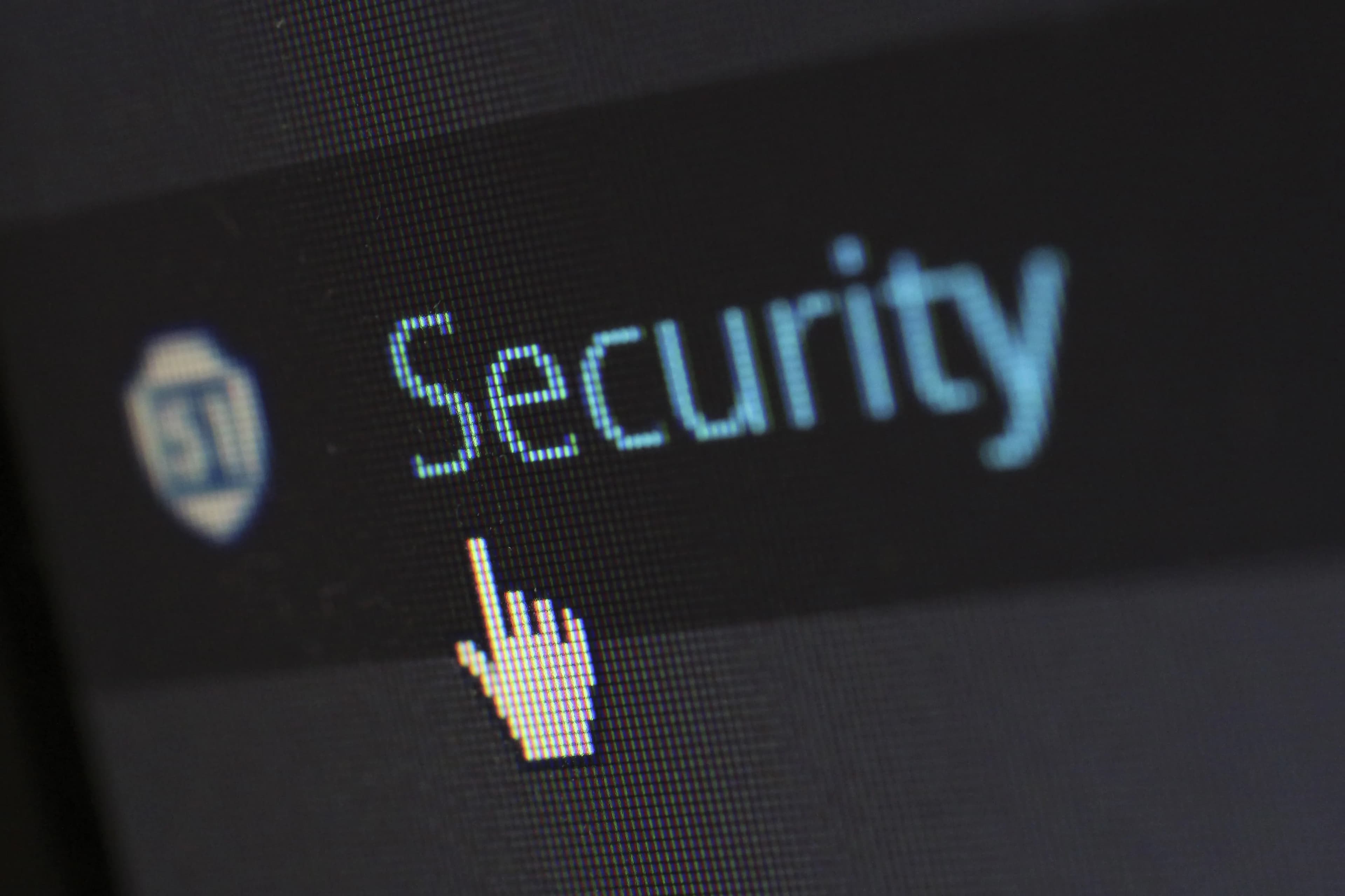 A cursor hovering over the word Security on a dark computer screen.