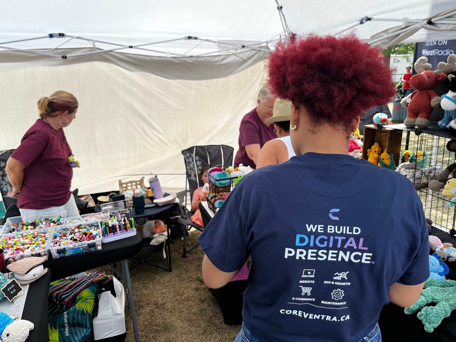 The back of a real Coreventra team T-shirt, listing Website, SEO & Growth, E-commerce, and Maintenance under "We Build Digital Presence"
